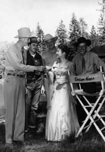 Actress Evelyn Keyes receives an invitation to a local community event from Judge Jack Mathew’s and Constable Coy Brown, while filming “Mrs. Mike” in 1949.