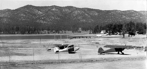 Most people arn't aware that Big Bear Village once had an airfield. It was located on the dry lake bottom where Pine Knot Landing is today. It only operated for acouple years in the mid 1940's. Stillwell's can be seen in the bacjground.